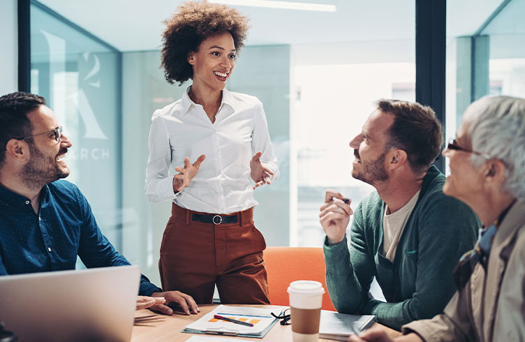 four individuals meeting in an office showing diversity in leadership
