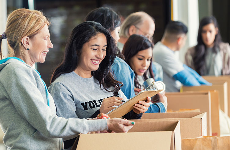 diverse-adults-packing-donation-boxes-in-charity-food-bank