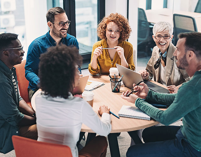 diverse business people collaborating around table