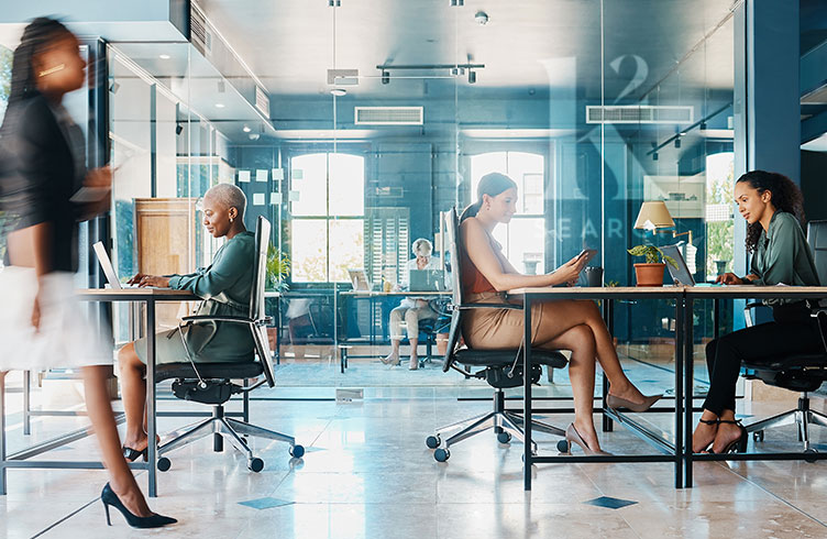 a diverse group of businesswomen working in a corporate office for marketing executive searches